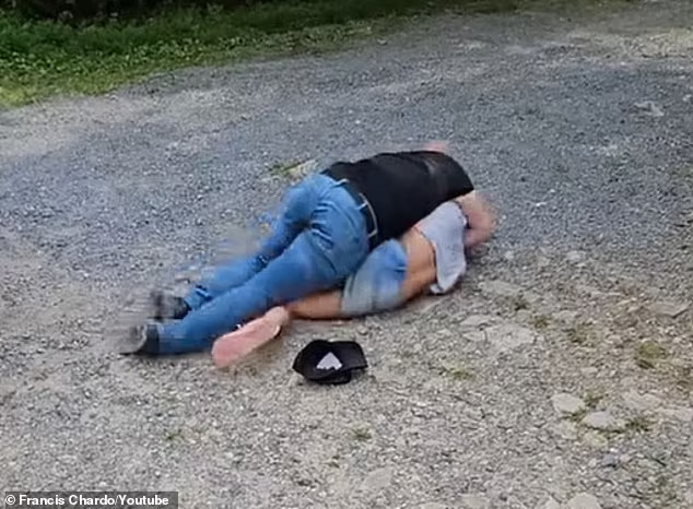 The woman repeatedly tells him that she cannot breathe, as Davis puts her in a 'wrestling style hold'